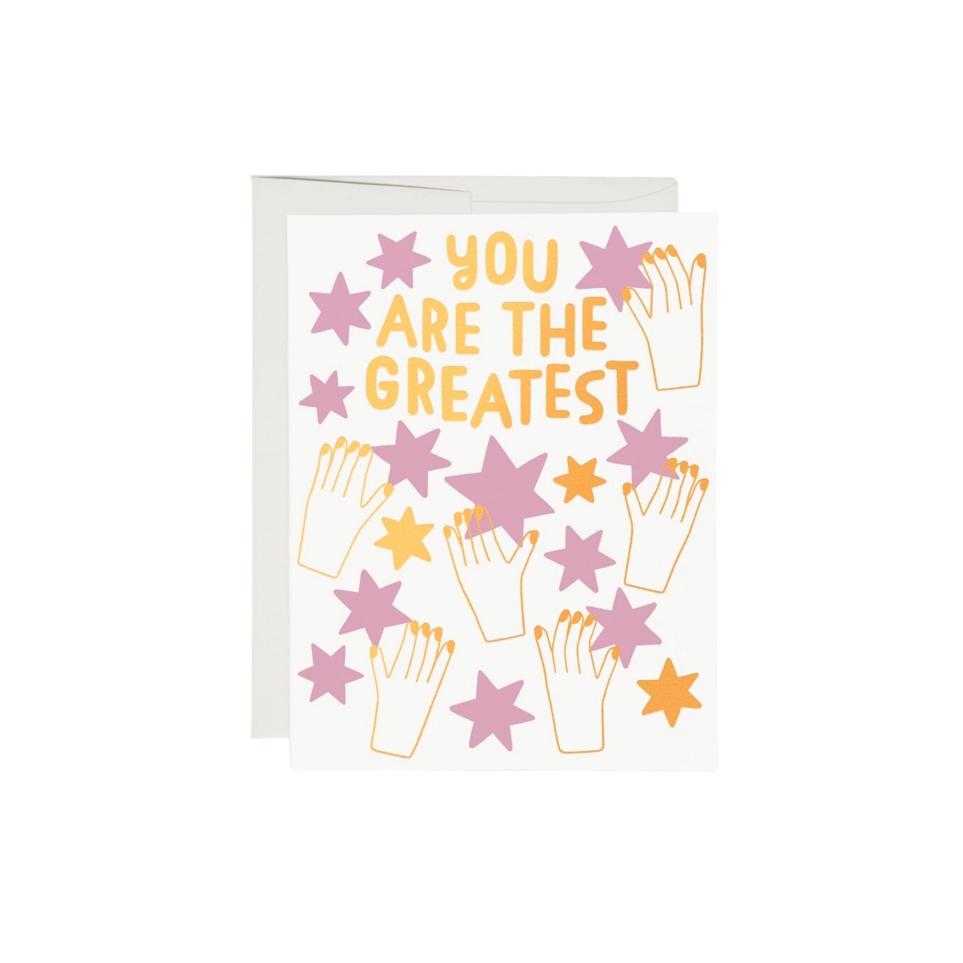 This 5.5"x4.25" card has a stars and says you are the greatest. gold illustration of hands  holding pink and gold stars.  100lb heavyweight card stock, foil-stamped offset printing, and a design illustrated by Anke Weckmann. Additionally, this card is blank inside and printed in the USA on recycled paper.  