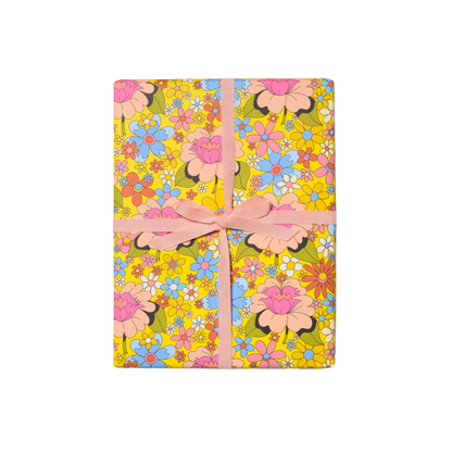 Colorful retro floral wrapping paper. Wrapped gift with Pink Bow