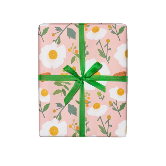 White flowers with green stems on a pink background. Sheet - Single (1) 19 x 27 inch sheet   Roll - Three (3) 19 x 27 inch sheets of flat wrap, rolled and sealed together.   Illustrated by Kate Pugsley. Printed in USA, on recycled paper.