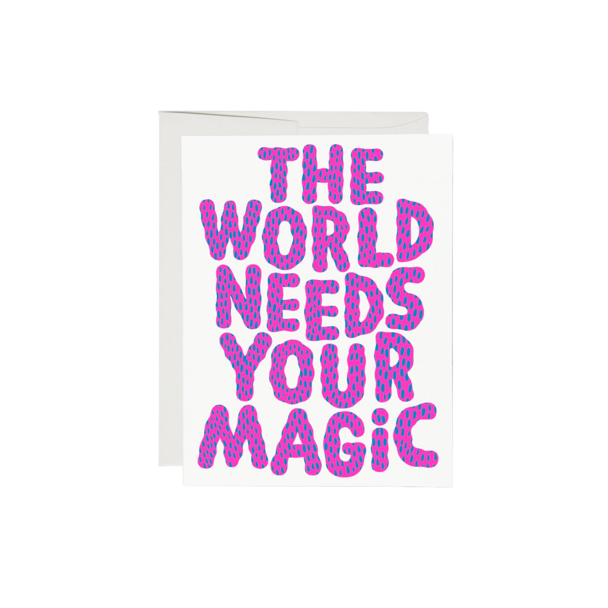 Pink and blue lettering on a white background reading "The World Needs Your Magic". The interior of the card is left blank, while the exterior is 100lb heavyweight card stock, with offset printing. Measuring 5.5 x 4.25 inches, the card features an illustration by Anke Weckmann and is printed in the USA on recycled paper.
